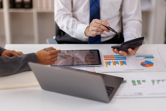 Business man investment consultant analyzing company annual financial report balance sheet statement working with documents graphs. Concept picture of business, market, office, tax.

