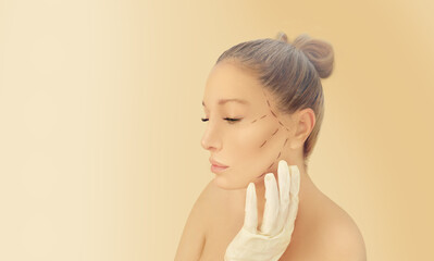 Marking the face.Perforation lines on females face, plastic surgery concept.