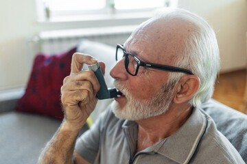 Senior man, asthma inhaler and breathe with pharmaceutical product, medical or healthcare. Elderly...