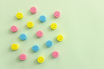 Concept image of satisfaction level. wooden cubes with happy emotions