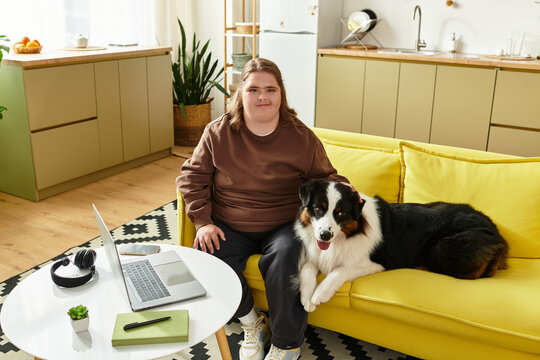 Young woman enjoying quality time with her dog in a cozy home setting while working