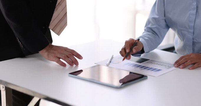 Female health insurance broker presenting his insurance benefits to businessman fill out insurance policy. To prevent future incidents.
