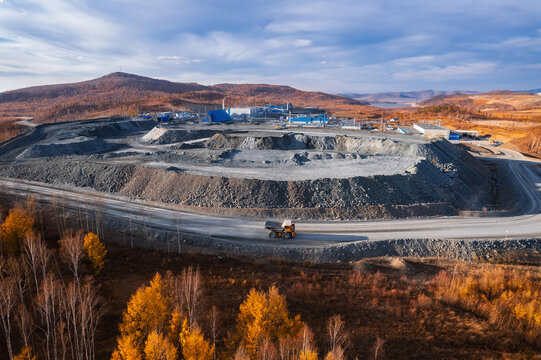 Panoramic of open pit mine industry, aerial view. Big yellow mining truck for coal working in quarry