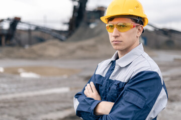 Caucasian male adult engineer in sand quarry - mining industry professional