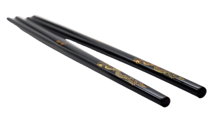Elegant black lacquered chopsticks with subtle engraved dragon on transparent background