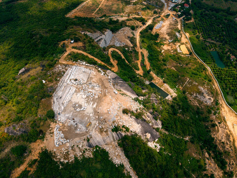 Aerial view of stone and marble quarry in lush green landscape