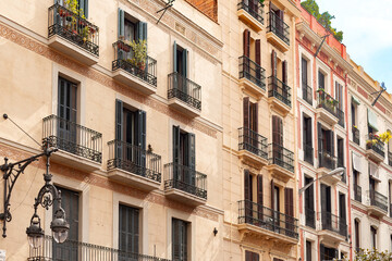 The charming facades and detailed craftsmanship of the apartment buildings in a central neighborhood of Barcelona, Spain.