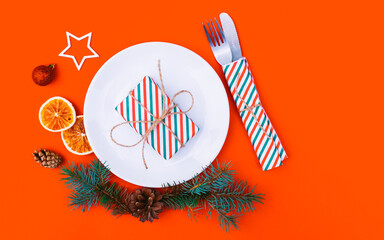 Christmas table setting for christmas dinner, served table with plate, gift, champagne glass, New...