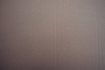 Fototapeta premium Texture of brown cardboard, natural paper surface with fine fibers and slightly uneven pattern