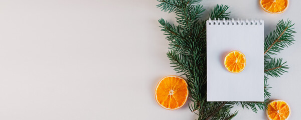 Blank open notebook mock up, to do list, wishlist for Santa, New year and Christmas goals. Christmas eve branch, dried orange, gift. Flat lay, top view, place for text