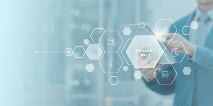 Sustainable Finance concept in modern business — professional using digital tablet with futuristic financial interface representing green economy, ESG investment, ethical banking