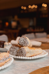 Rolls filled with chocolate on a restaurant table.