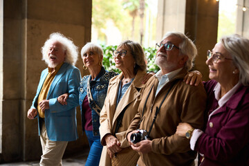 Group of senior friends sightseeing outdoors during city trip