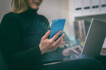 Financial analysis. Woman uses phone and laptop. Businesswoman analyzes and reviews economic data