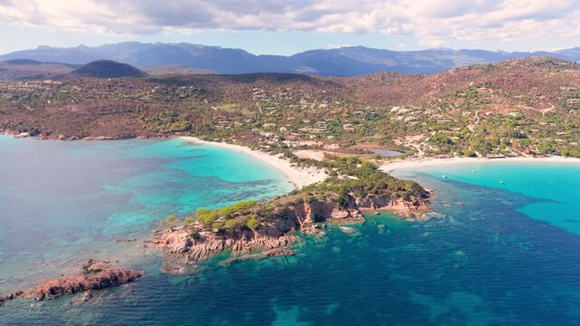 sunny corsican scenic panorama, serene turquoise waters with lush pinecovered headlands visible. France