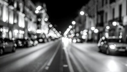 Night city street scene with blurred lights and cars, black and white