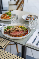 Savory roast beef served on a stylish outdoor table at a modern dining location during lunchtime