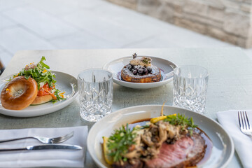 Delicious dishes at a modern restaurant table featuring gourmet food and elegant drinks during lunch hour