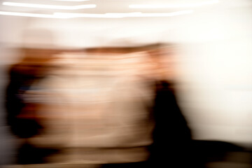 People walking with motion blur in abstract warm tones