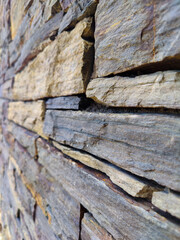 Rock wall featuring a rustic slate stone pattern
