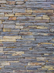 Stacked stone wall creating natural rock pattern background