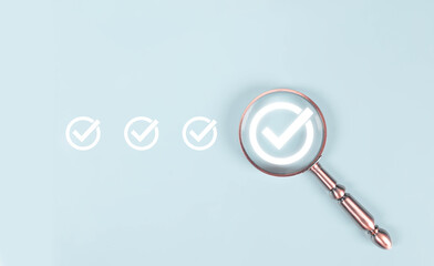 Magnifying glass highlighting a check mark icon on light blue background, representing quality...