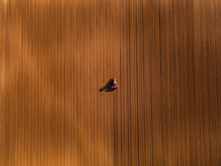 Tractor planting agricultural field, preparing soil for planting