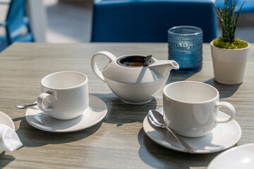 Enjoying a relaxing tea experience at a cozy cafe during a sunny afternoon