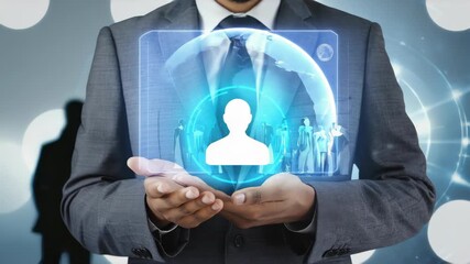 businessman in dark suit holding a glowing holographic human icon with group of people in the background - Powered by Adobe