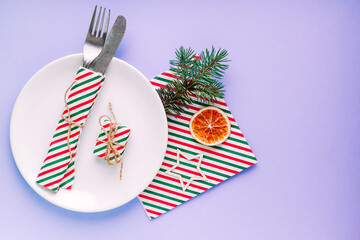 Christmas table setting for christmas dinner, served table with plate, gift, champagne glass, New...