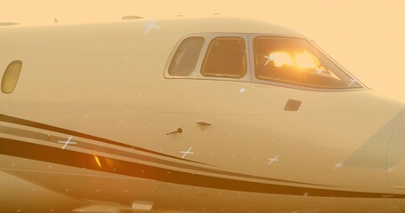 Showing jet fuselage and cockpit windows reflecting golden-hour light on tarmac, with sensors