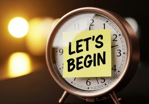 Close up of a vintage alarm clock with a yellow sticky note that says lets begin