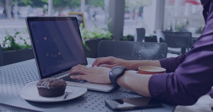 Typing Asian man wearing smartwatch at cafe with laptop, muffin, fork, coffee, phone, copy space