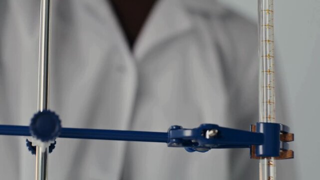Close-up 4K Ultra HD footage of liquid rising inside a glass burette during a chemical experiment in a laboratory, showing precise measurement and scientific analysis in detail
