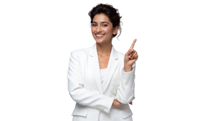 Happy Indian businesswoman in a white suit smiles brightly, pointing upwards with an engaging and insightful expression, isolated on transparent background