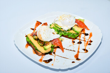 Sandwich with poached eggs and vegetables