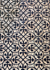 Random round ornamental floral pattern. 3D laser cutting panels at wall finishes or screens. Random flower swirls in black paint with wood background. Seamless background texture.