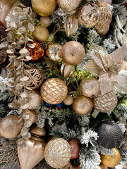 Close up christmas tree decoration from baubles, tinsels, mistletoe, ribbon, snowflakes, and many more.