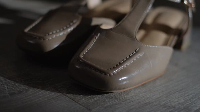 Close-up of women's beige patent leather shoes