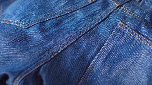 Close-up of blue jeans stitched with yellow thread
