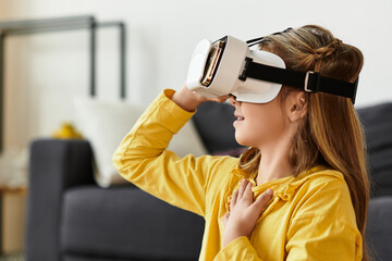 Girl explores new worlds at home with virtual reality headset in her casual outfit