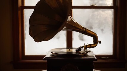 Vintage gramophone playing music near window with snow falling outside on a cold winter day indoors - Powered by Adobe