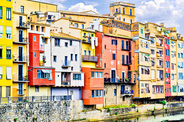 Colorful houses along the Onyar River, also known as hanging houses, in the city of Girona,...