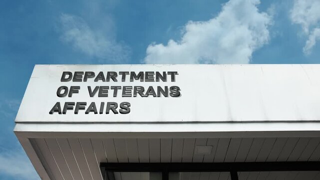 Department of Veterans Affairs word sign displayed on building facade with clear blue sky, highlighting a government institution dedicated to supporting veterans and their families.