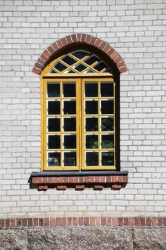 Window with yellow window frame in white brick wall, former paper factory and mill for the production of groundwood pulp board, UNESCO World Heritage Site Factory Village Verla, Maailmanperint&ouml;kohde Verlan puuhiomo ja pahvitehdas, Verla Rapids, Kymenlaakso, near Kouvola, Finland