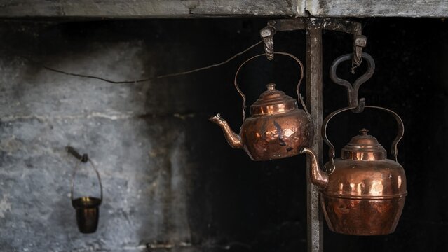 Alte Kupferkessel, die an Haken in einer rustikalen K&uuml;che h&auml;ngen, historischer Bauernhof und Pilgerunterkunft Budsjord, Dovre, Pilgerweg Olavsweg oder Olavsleden, Gudbrandsdalen oder Gudbrandstal, Norwegen