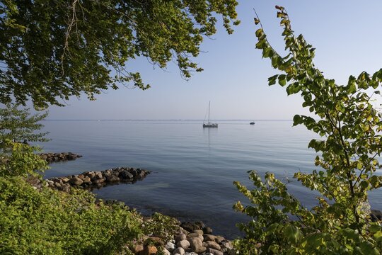 Sailing ship lying off the coast on a calm, sunny day, Humbleb&aelig;k, Niv&aring; Bugt, Hovedstaden, &Oslash;resund coast, Denmark