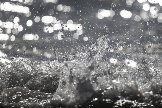 Splashing water against the light, surf, S&oslash;ndervig Strand, North Sea, Denmark