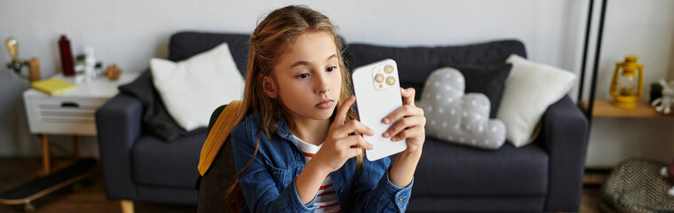 Girl enjoying a relaxing moment at home in casual outfit with her smartphone