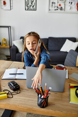 Young girl enjoys a casual day at home with phone, laptop and creative workspace